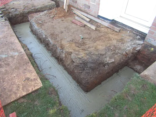 Concrete going into a footing trench