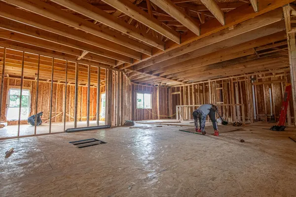 House framing standing on a concrete slab foundation in The Colony, Texas