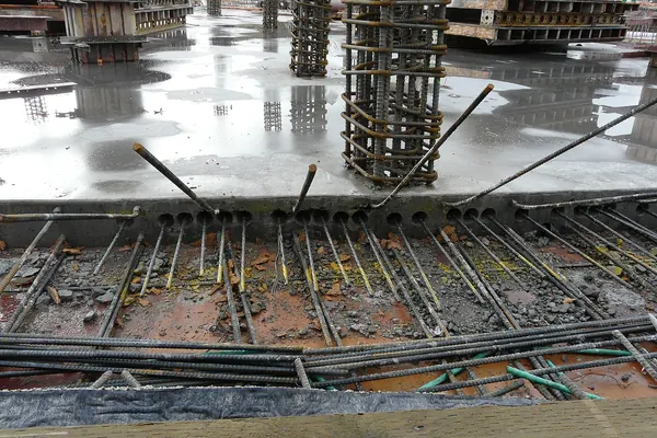 Post-tensioning tendon ends sticking out of the edge of a concrete slab