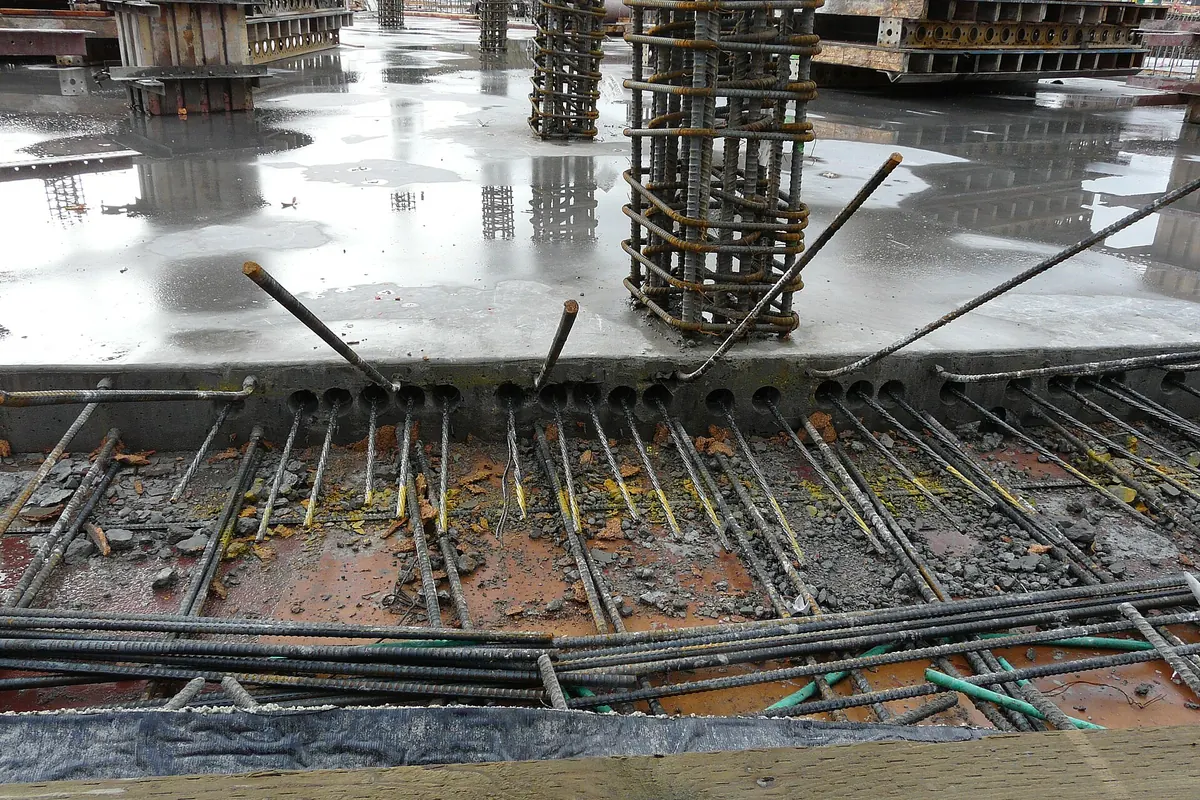 Post-tensioning tendon ends sticking out of the edge of a concrete slab
