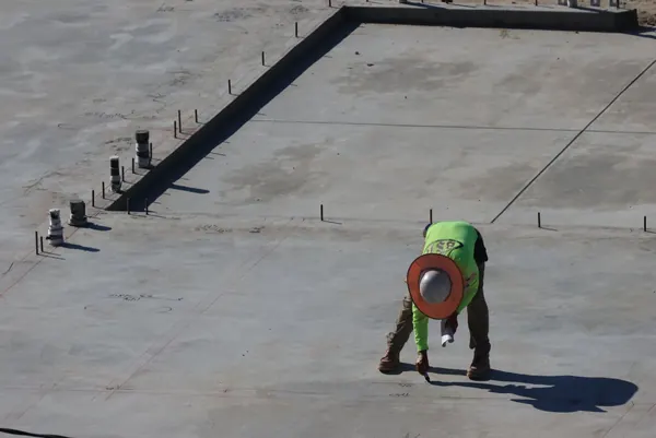 Plumbing stubs and vapor retarder set in a formed house slab before the pour